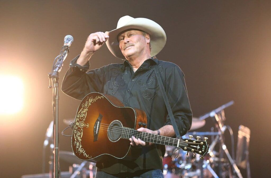 Uma guitarra e um chapéu de cowboy em um cenário rural