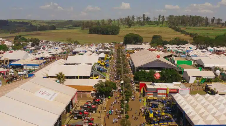 Imagem de uma feira de agronegócio com tratores e equipamentos agrícolas expostos