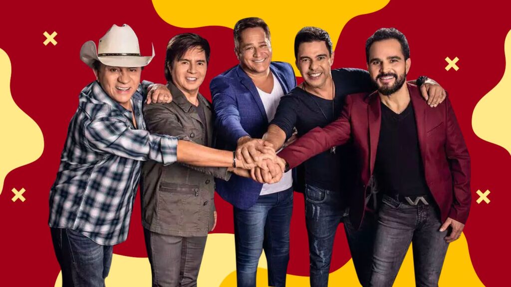 Um grupo de músicos sertanejos se apresenta em um palco com iluminação aconchegante, trazendo as raízes da música country brasileira.